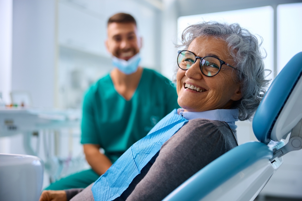 Happy senior woman at Dental Clinic looking at a camera