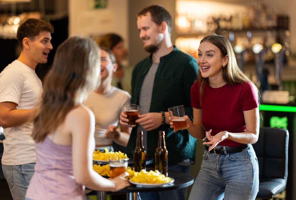 Group of friends and fan having fun chatting and drinking beer