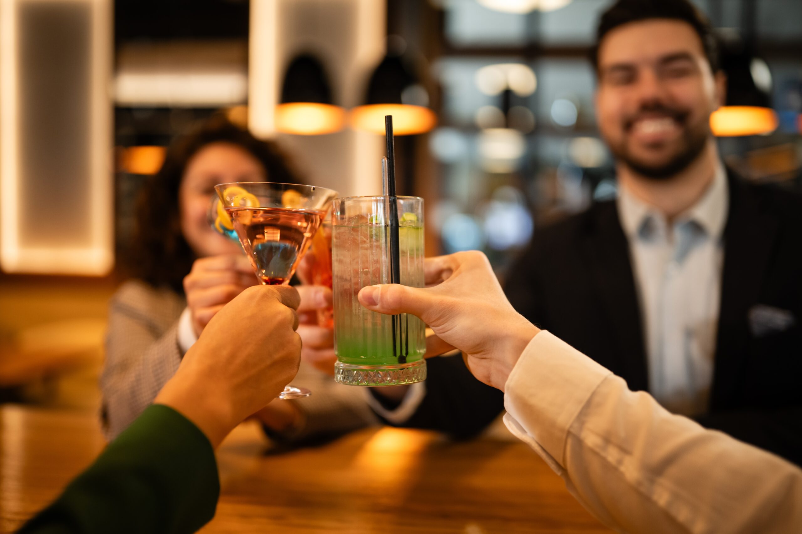 Guests raising cocktails together during a group celebration at an event venue scaled