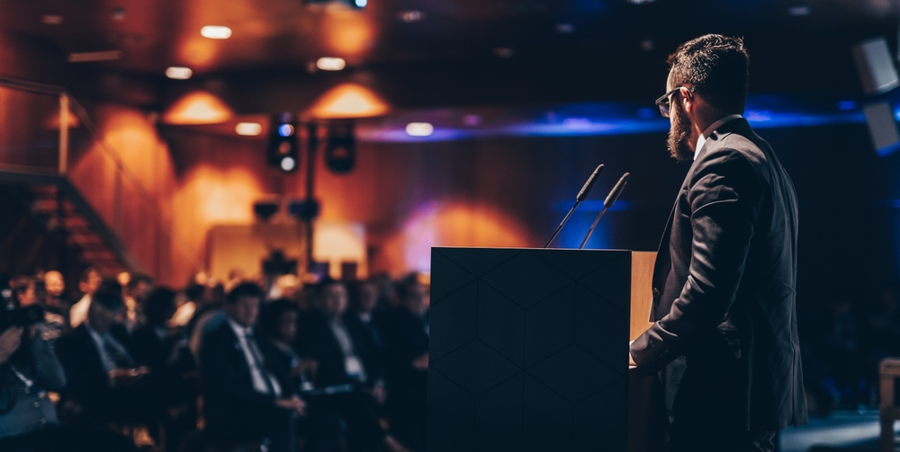 Speaker giving a talk on corporate business conference unrecognizable people